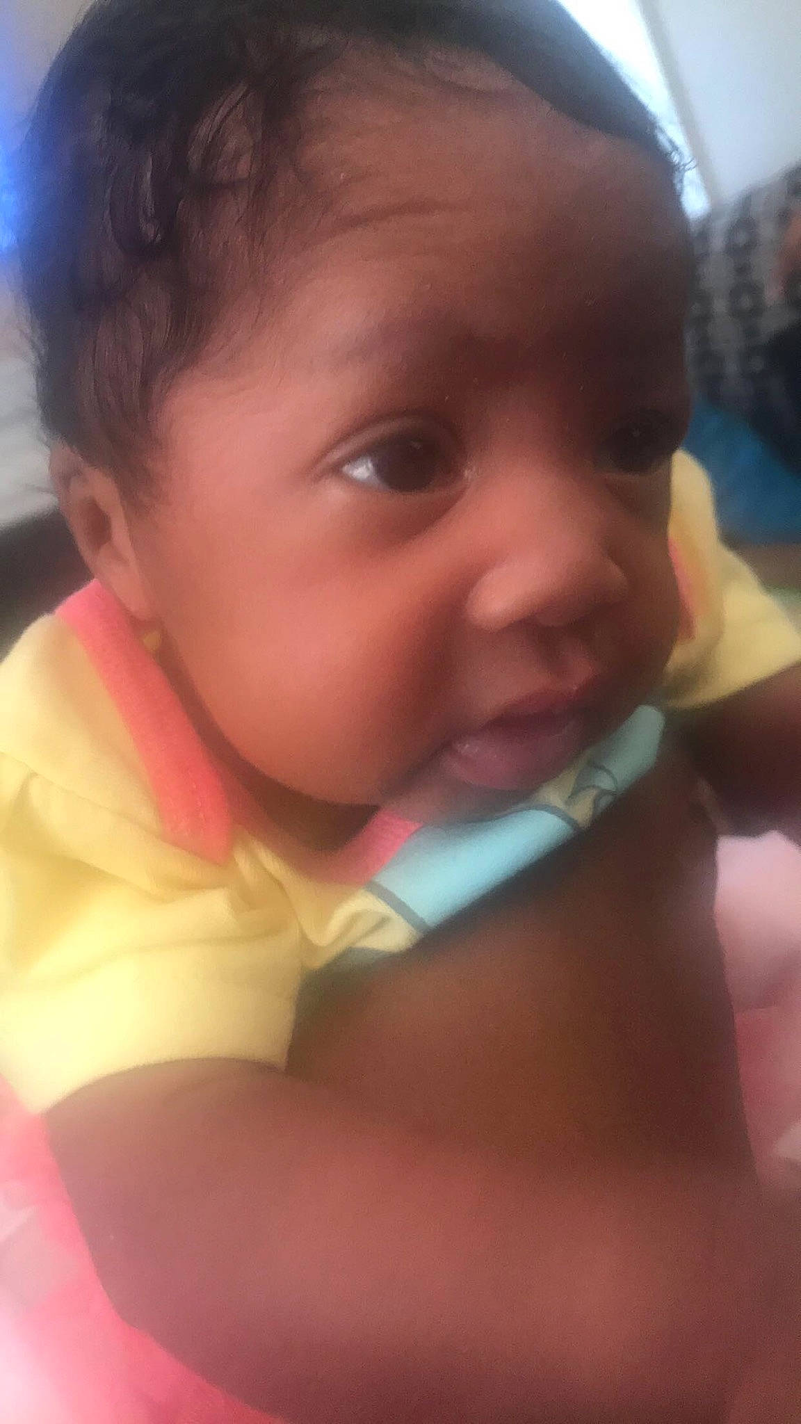 Carmen is registered to the contest to win money with this photo: black_hair, cheek, child, chin, close_up, day, eye, eyebrow, face, finger, forehead, girl, hand, head, infant, lip, mouth, nose, person, skin