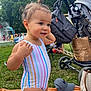 Ariah participe au concours pour gagner de l'argent avec cette photo : toddler, child, swimsuit, outdoor, park, grass, stroller, hat, bag, blanket, smiling, people, trees, sky, playground, water_splash, summer, daytime, cute, happy