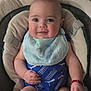 Liam joined the competition — help win amazing prizes! baby, infant, smiling, face, blue_clothing, bib, bracelet, cushion, seat, child, person, happy, indoor, skin, arm, hand, head, eyes, puma, comfortable