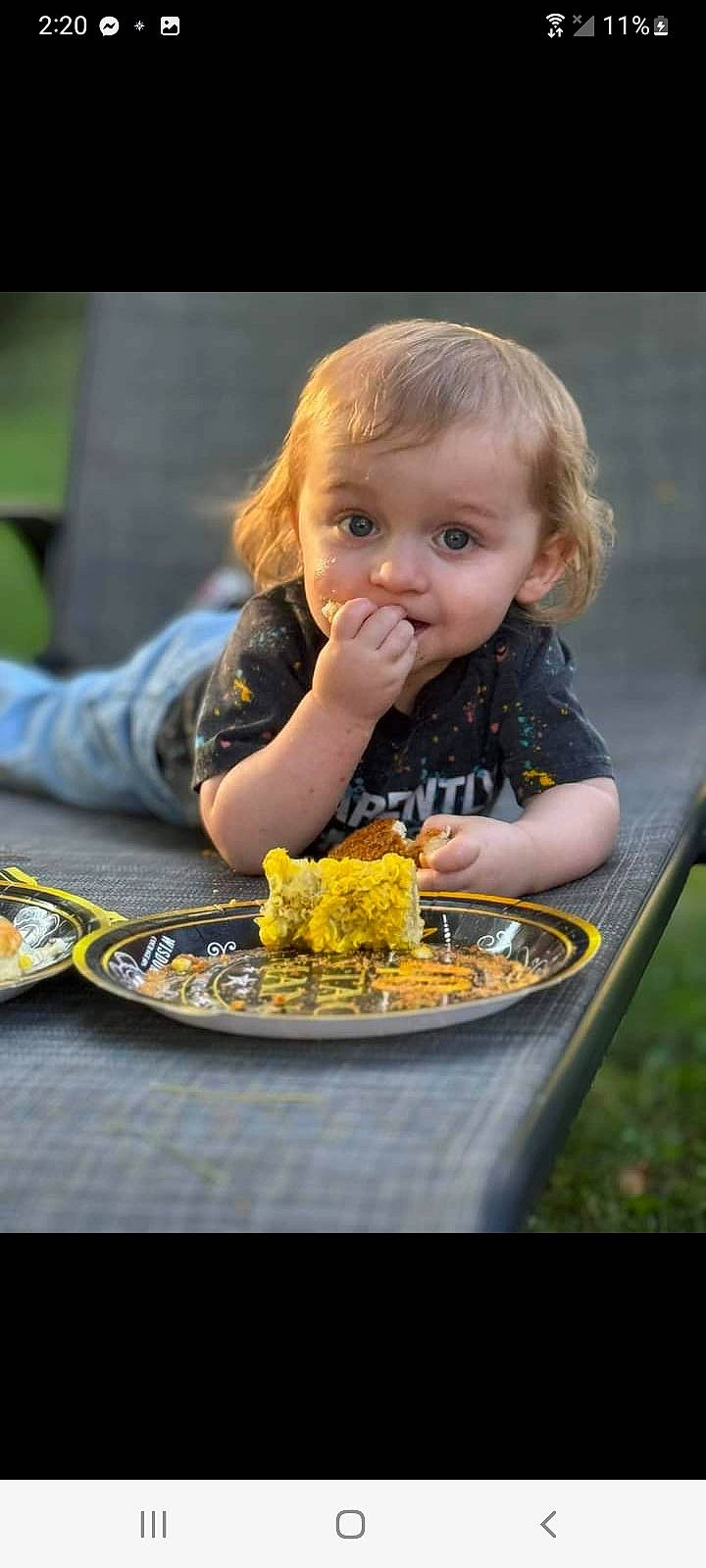 Bradley is registered to the contest to win money with this photo: biting, blond, child, comfort_food, cuisine, dish, food, food_craving, fun, grass, happy, iris, junk_food, person, recipe, recreation, sharing, sitting, table, tableware