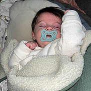 Lyam participe au concours pour gagner de l'argent avec cette photo : baby, pacifier, sleeping, blanket, white_clothing, infant, cozy, soft_texture, face, head, indoor, resting, child, comfort, cushion, bed, nap, peaceful, young, wrapped