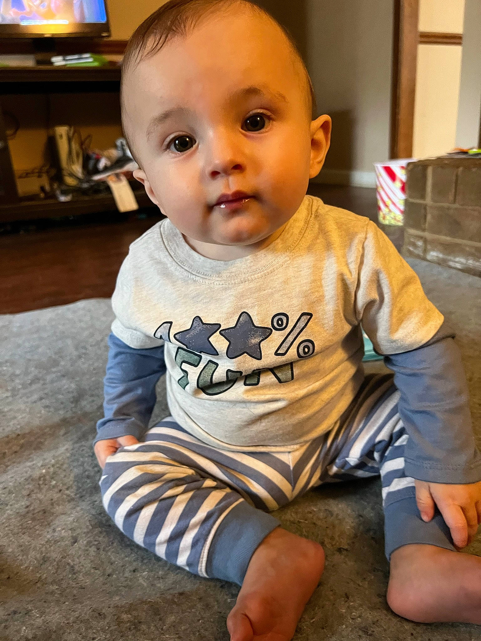 Aziel joined the competition — help win amazing prizes! baby, baby_toddler_clothing, cheek, child, comfort, eye, floor, flooring, fun, happy, human_leg, knee, person, sitting, skin, sleeve, standing, t_shirt, television, thigh