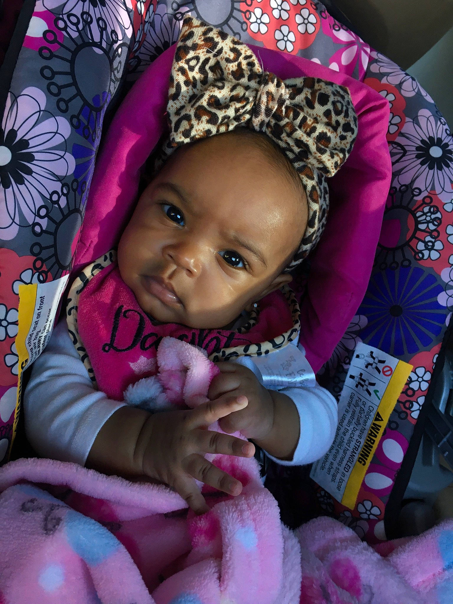 Journei is registered to the contest to win money with this photo: baby, baby_products, car_seat, cheek, child, hair_accessory, headgear, person, pink, smile, toddler