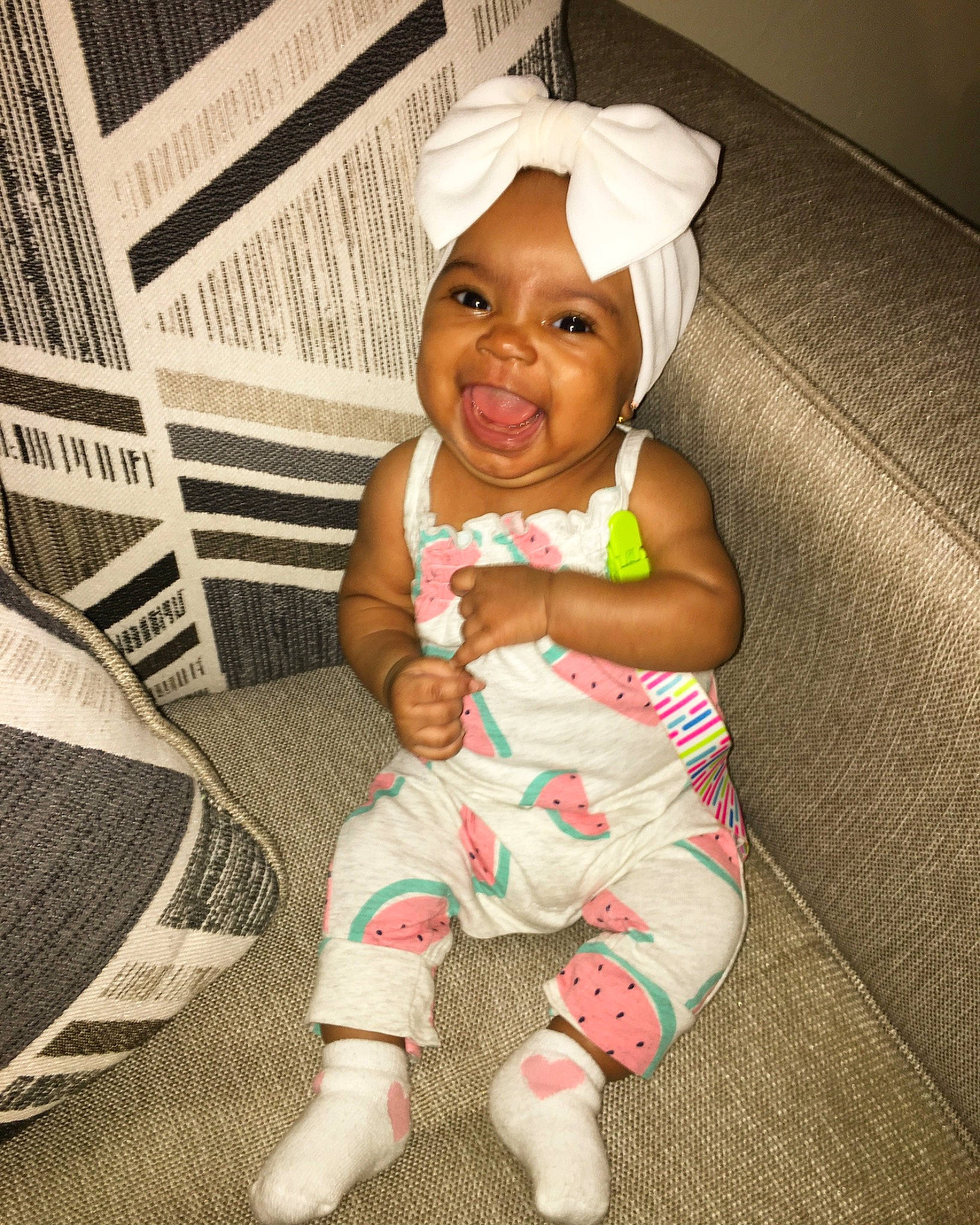 Journei is registered to the contest to win money with this photo: baby, baby_toddler_clothing, cheek, child, happy, headgear, people, person, pink, product, sitting, skin, smile, toddler