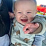 Jaxson is registered to the contest to win money with this photo: baby, child, smiling, happy, reaching, pajamas, bear_pattern, person_holding, jacket, outdoor, daylight, red_truck, background, portrait, cute, infant, hand, face, clothing, expression