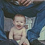baby, child, person, smiling, jeans, shoes, hat, floor, wood, bucket, diaper, hands, legs, sitting, happy, indoor, casual_clothing, adult, dirt, candid