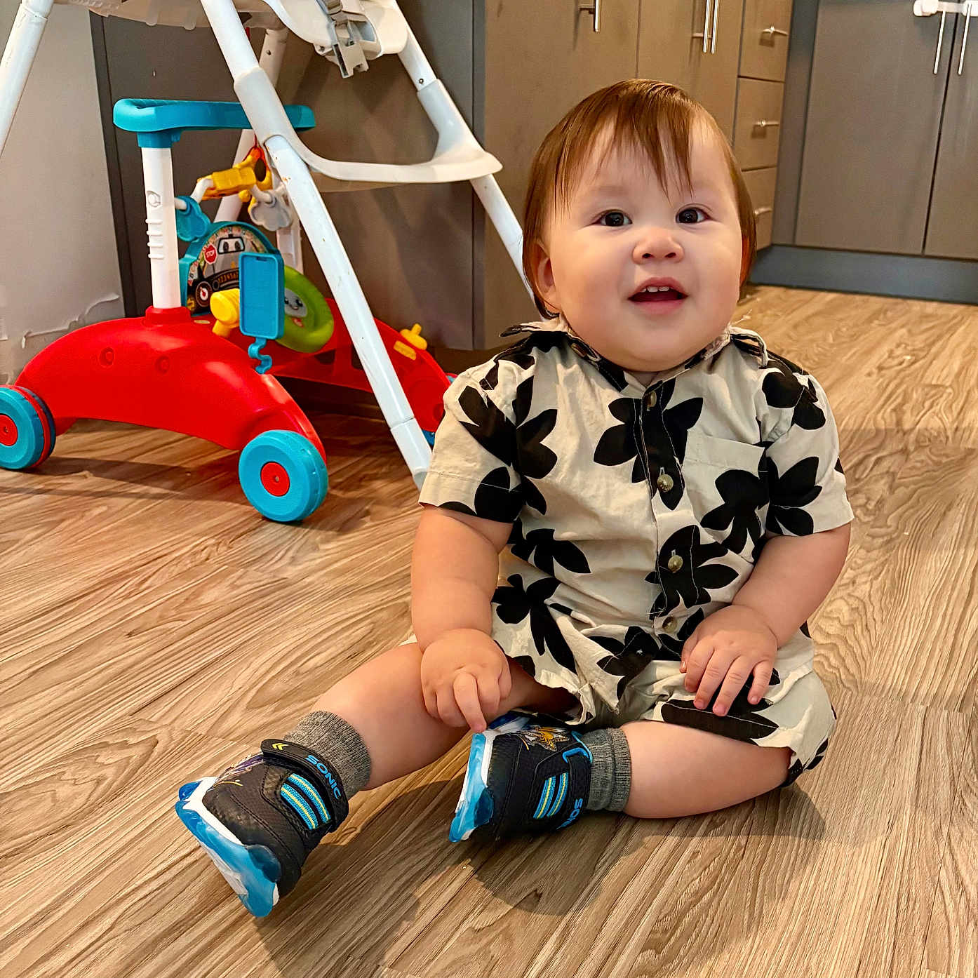 Gabriel García joined the competition — help win amazing prizes! baby, cabinet, child, clothing, cute, drawer, floor, happy, home, indoor, infant, kitchen, person, shoes, shorts, sitting, smiling, toy, walker, wooden_floor