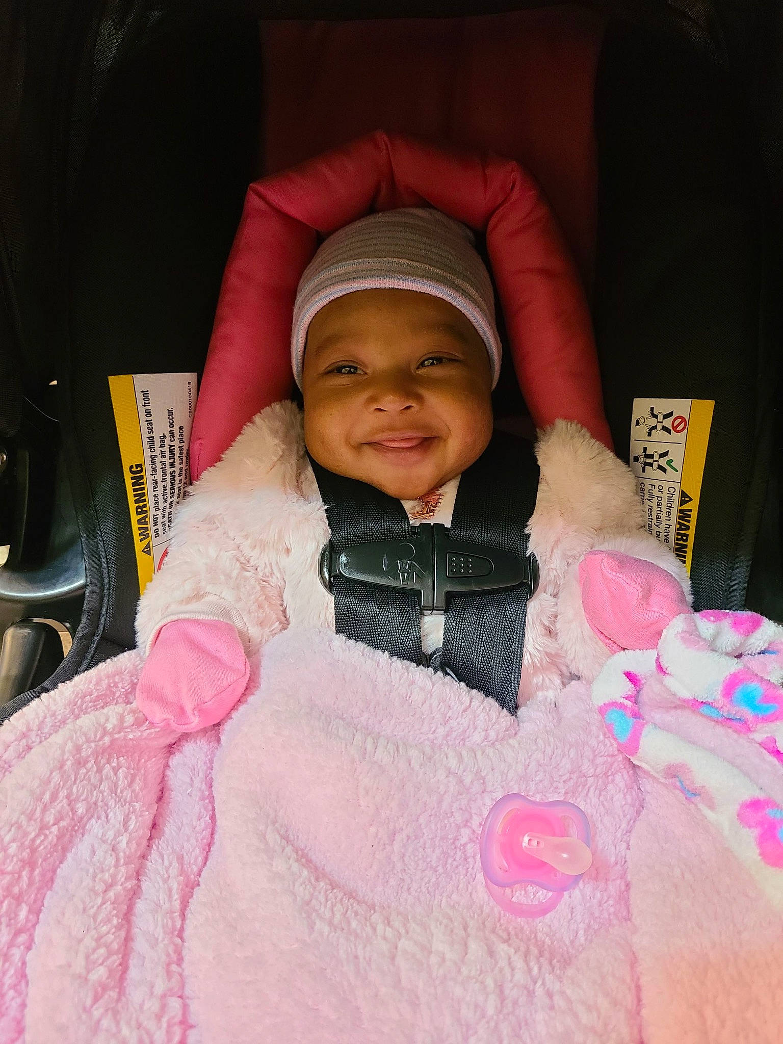 Kayleigh is registered to the contest to win money with this photo: baby, baby_products, baby_toddler_clothing, car_seat, cheek, comfort, eye, finger, fun, happy, headwear, human_body, joy, lip, magenta, nose, person, pink, skin, sleeve