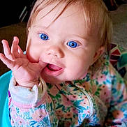 Ava joined the competition — help win amazing prizes! baby, child, blue_eyes, pigtails, baby_walker, colorful, hand, smile, indoor, clothing, playful, cute, face, portrait, young_child, expression, person, infant, sitting, happy