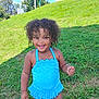 Bessie is registered to the contest to win money with this photo: child, toddler, curly_hair, blue_swimsuit, smiling, outdoor, grass, sunny, happy, summer, nature, playful, young_child, standing, greenery, daylight, person, cute, skin, portrait