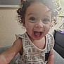Leighlanni is registered to the contest to win money with this photo: child, toddler, curly_hair, smiling, indoor, patterned_clothing, happy, face, person, cute, sitting, bright_eyes, infant, playful, portrait, young_child, casual, home, light, expression