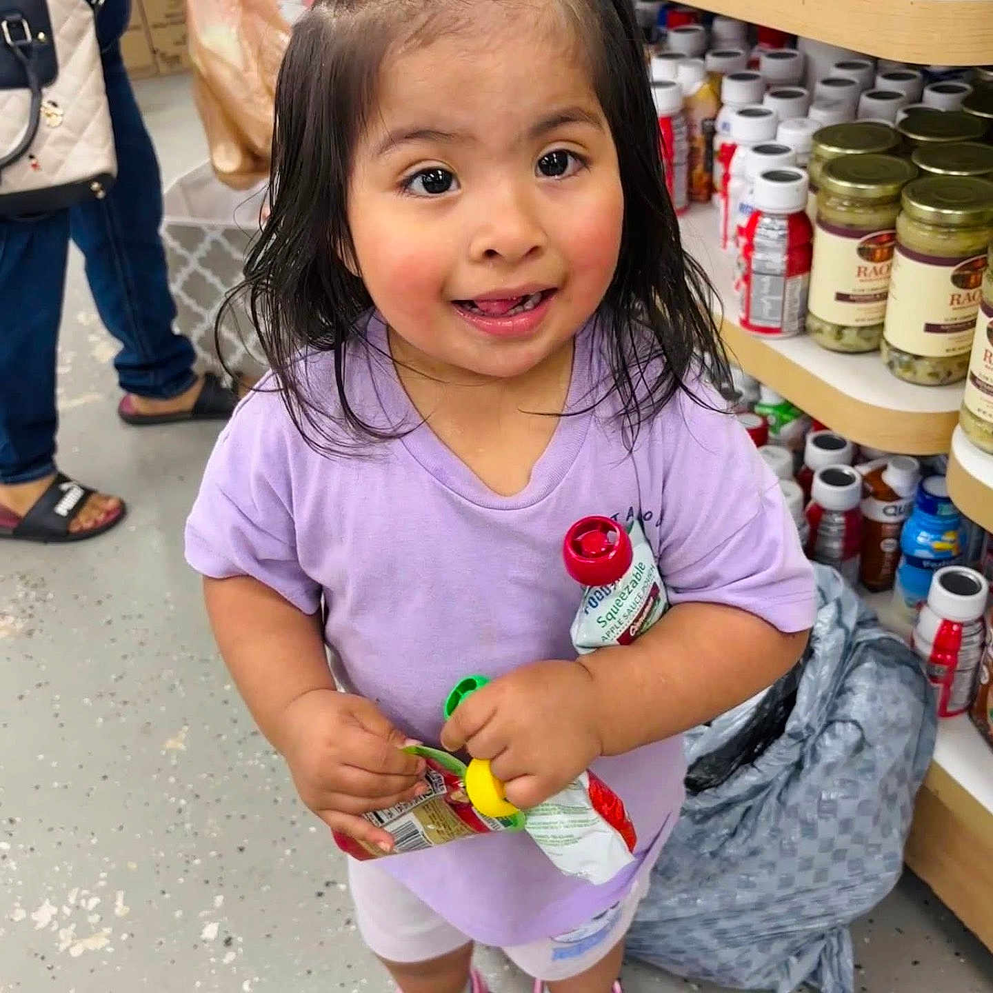Danna Tecongo Valle joined the competition — help win amazing prizes! aisle, bottles, casual_clothing, child, floor, girl, happy, indoor, jars, person, pink_hair_tie, pink_shoes, plastic_bag, purple_shirt, shelves, shopping, smiling, squeeze_pouches, store, toddler