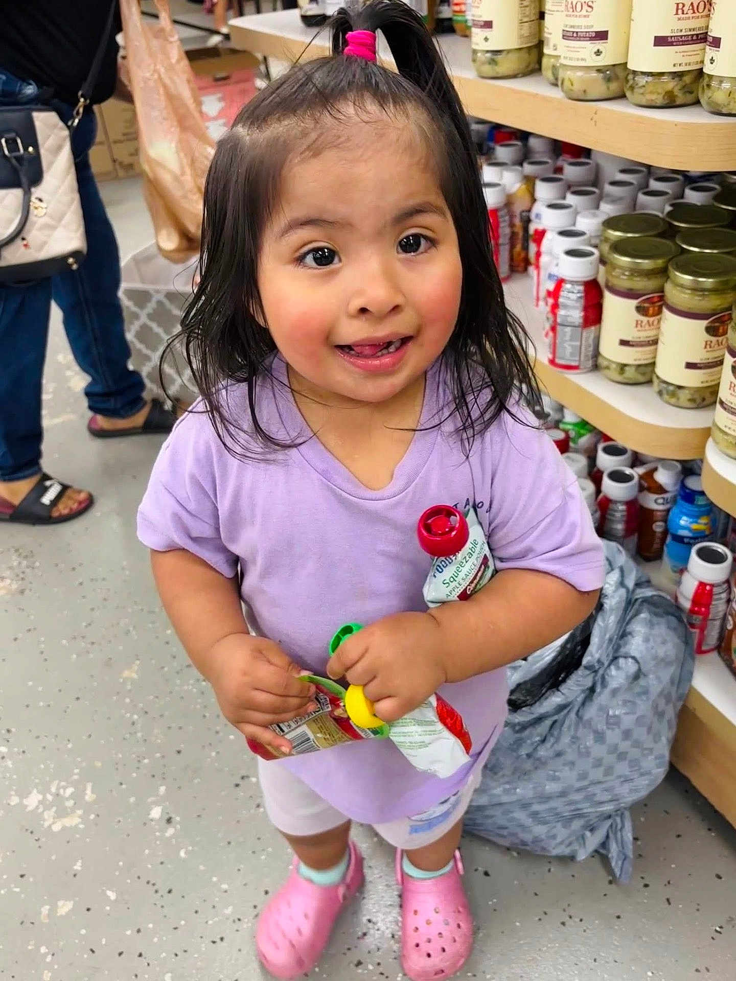 Danna Tecongo Valle joined the competition — help win amazing prizes! aisle, bottles, casual_clothing, child, floor, girl, happy, indoor, jars, person, pink_hair_tie, pink_shoes, plastic_bag, purple_shirt, shelves, shopping, smiling, squeeze_pouches, store, toddler