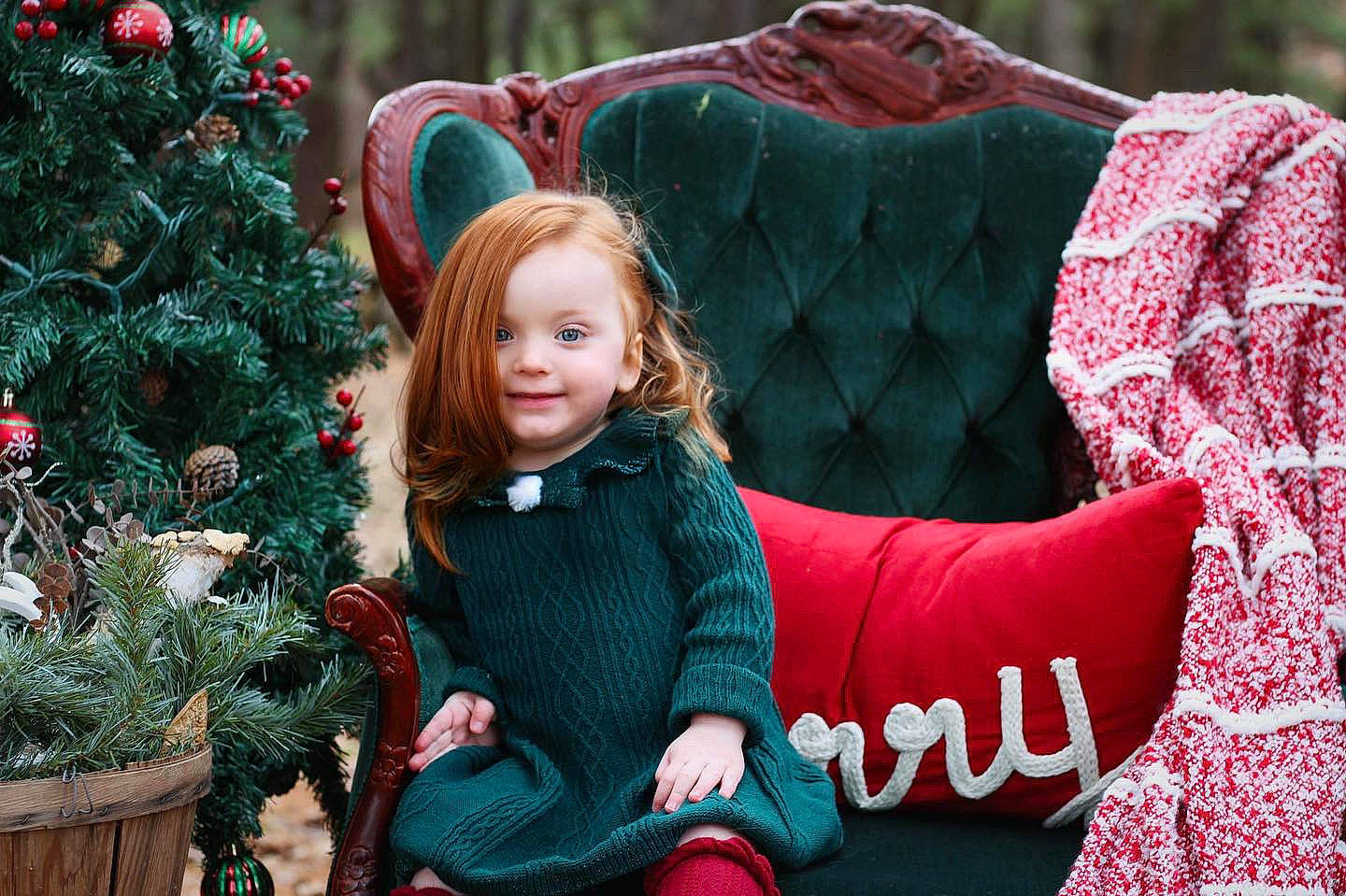 Mazie June joined the competition — help win amazing prizes! christmas, christmas_decoration, christmas_ornament, christmas_tree, facial_expression, grass, green, hair, happy, head, holiday, joy, leisure, mammal, people, people_in_nature, person, plant, red, smile