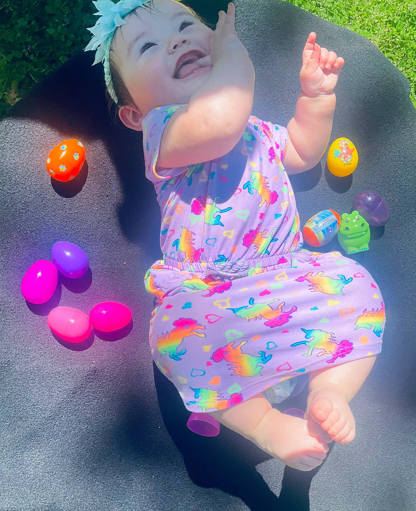 Georgia is registered to the contest to win money with this photo: baby_toddler_clothing, beauty, dress, entertainment, facial_expression, finger, fun, gesture, grass, hand, happy, hat, human_leg, leg, leisure, light, magenta, person, pink, smile