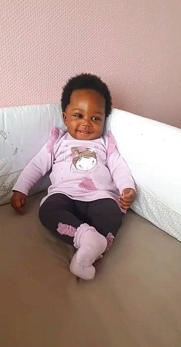 Inna participe au concours pour gagner de l'argent avec cette photo : ankle, baby, baby_toddler_clothing, barefoot, cheek, child, comfort, finger, floor, foot, human_body, joy, knee, linens, person, pink, product, sitting, skin, sock