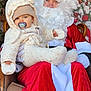 baby, child, santa_claus, christmas_tree, holiday_decor, winter_clothing, pacifier, beard, glasses, chair, red_clothing, white_fur, indoor, festive, smiling, portrait, seasonal, hat, cozy, warm