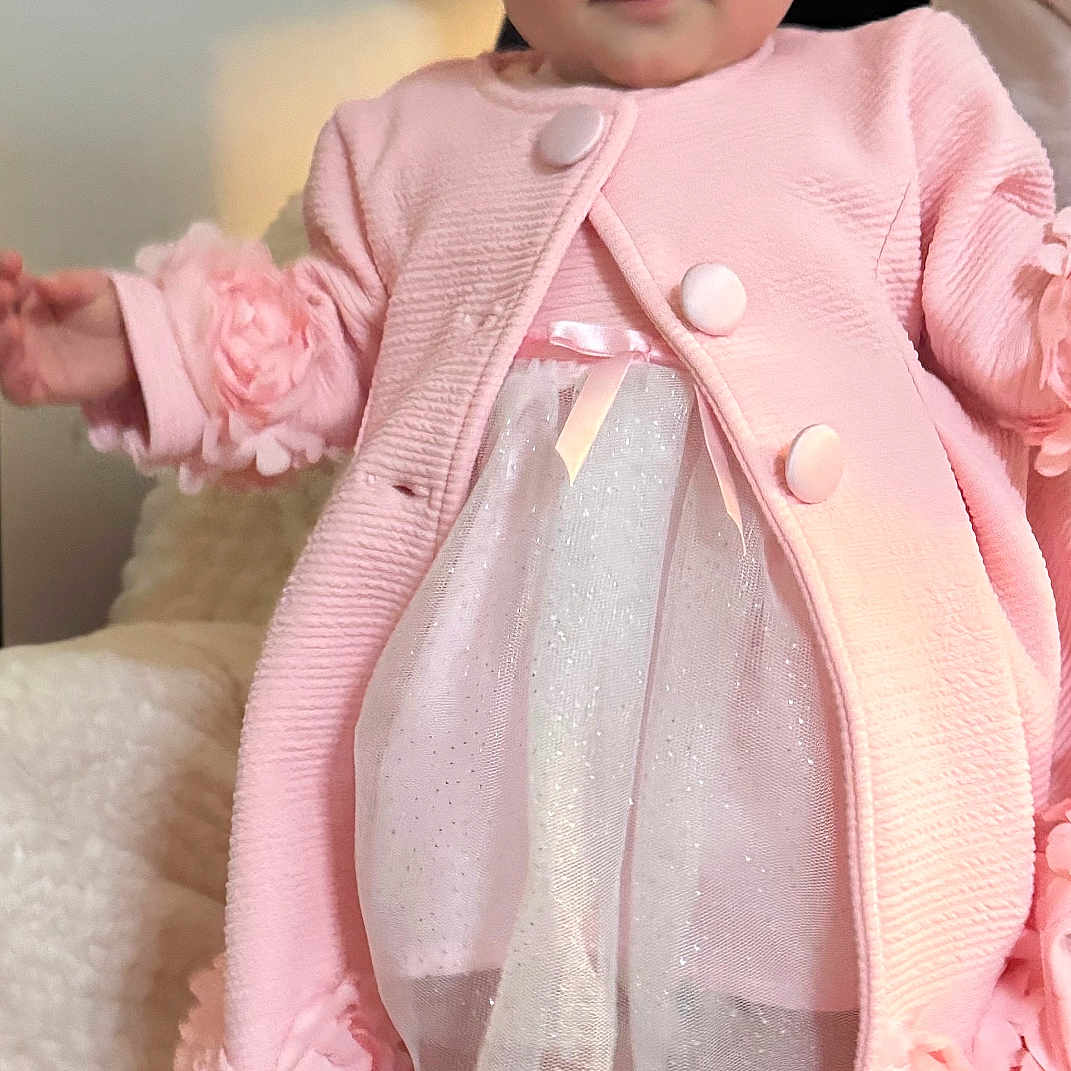 Scarlett is registered to the contest to win money with this photo: adult, baby, clothing, coat, doll, dress, face, female, formalwear, head, knitwear, longsleeve, person, photography, portrait, sitting, sleeve, sweater, toy, woman