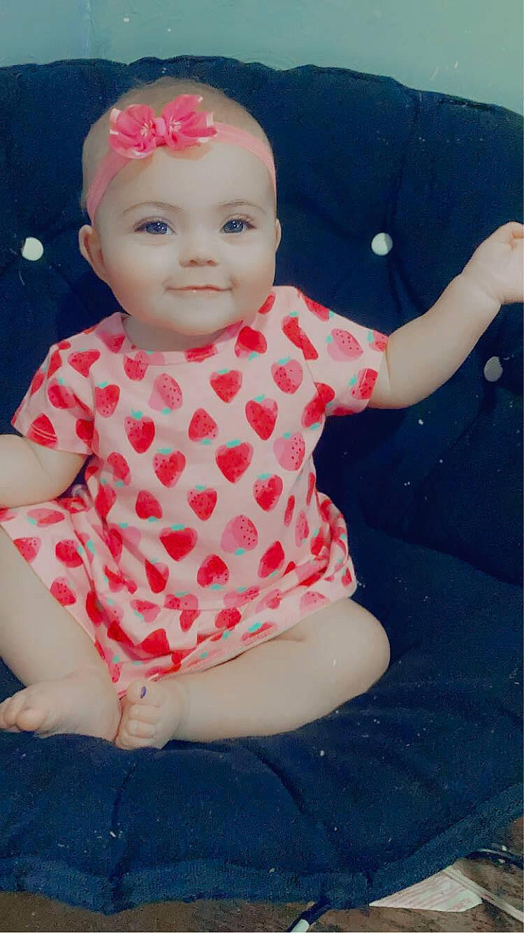 Athena is registered to the contest to win money with this photo: baby, baby_toddler_clothing, cheek, child, chin, clothing, dress, eye, face, happy, head, joy, lip, magenta, one_piece_garment, pattern, person, pink, skin, sleeve