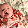 Anora is registered to the contest to win money with this photo: baby, infant, face, open_mouth, onesie, patterned_clothing, peach_pattern, hand, fist, blanket, floral_blanket, lying_down, cute, expression, child, newborn, skin, head, eyes, mouth