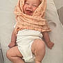 baby, infant, smiling, happy, cloth, blanket, white_onesie, lying_down, cute, skin, legs, arms, face, headwear, indoors, soft_texture, fabric, child, joyful, expression