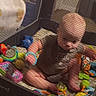 Atlas joined the competition — help win amazing prizes! baby, baby_clothing, barefoot, blanket, child, colorful_toys, cozy, cushion, home, indoor, infant, lying_down, mesh, no_face_visible, nursery, plastic_toys, playmat, playpen, sitting, toys