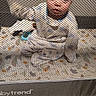 baby, blanket, blue, carpet, child, clothing, crib, curious, face, furniture, home, indoor, infant, mesh, nursery, playpen, portrait, sitting, toys, white