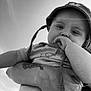 Valentin a rejoint le concours — aidez-le/la à gagner de superbes lots ! arm, baby, black_and_white, casual, child, closeup, clothing, cute, expression, face, hand, hat, holding, infant, outdoor, person, portrait, sitting, sky, tattoo