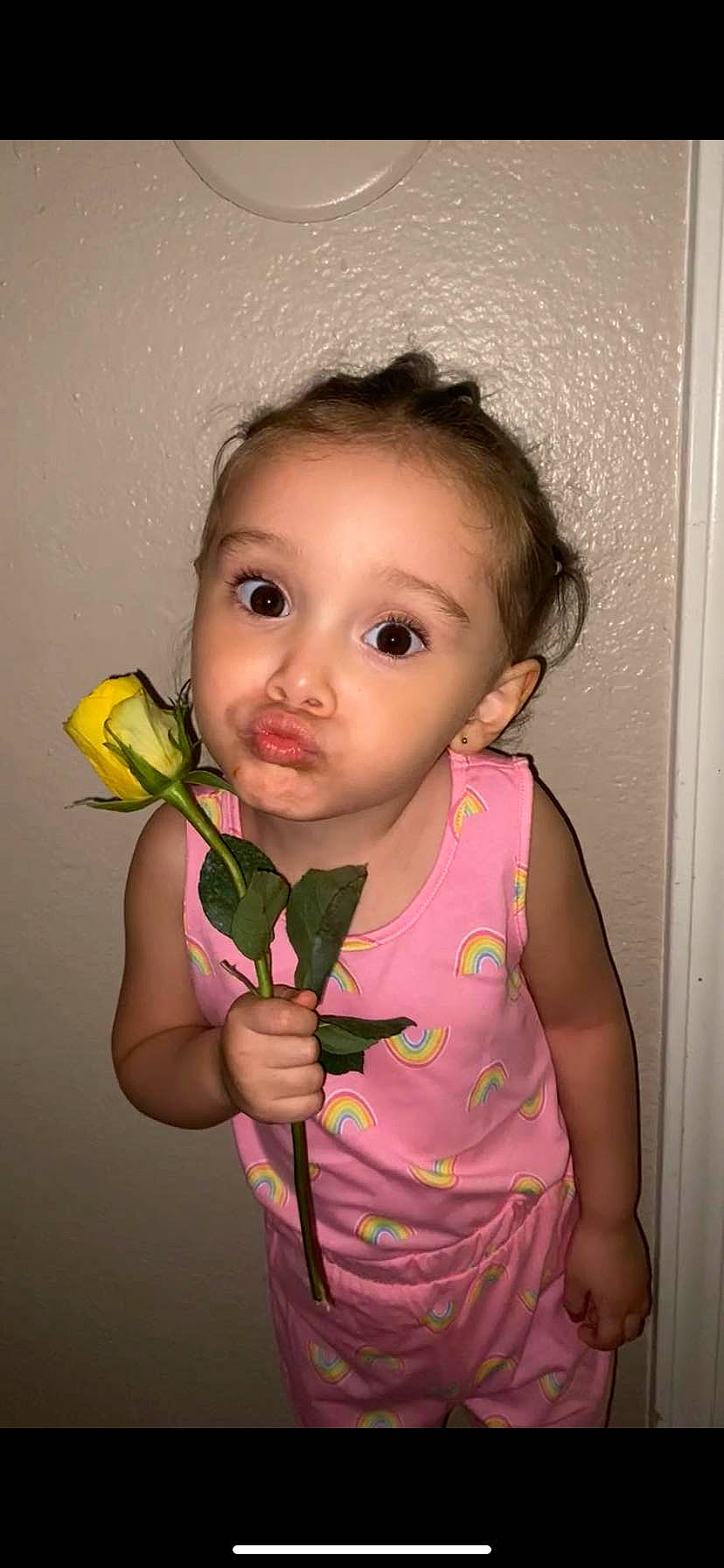 Amora is registered to the contest to win money with this photo: baby, baby_toddler_clothing, cheek, chin, eye, eyelash, finger, flash_photography, gesture, hand, happy, iris, lip, nose, person, petal, pink, plant, skin, sleeve