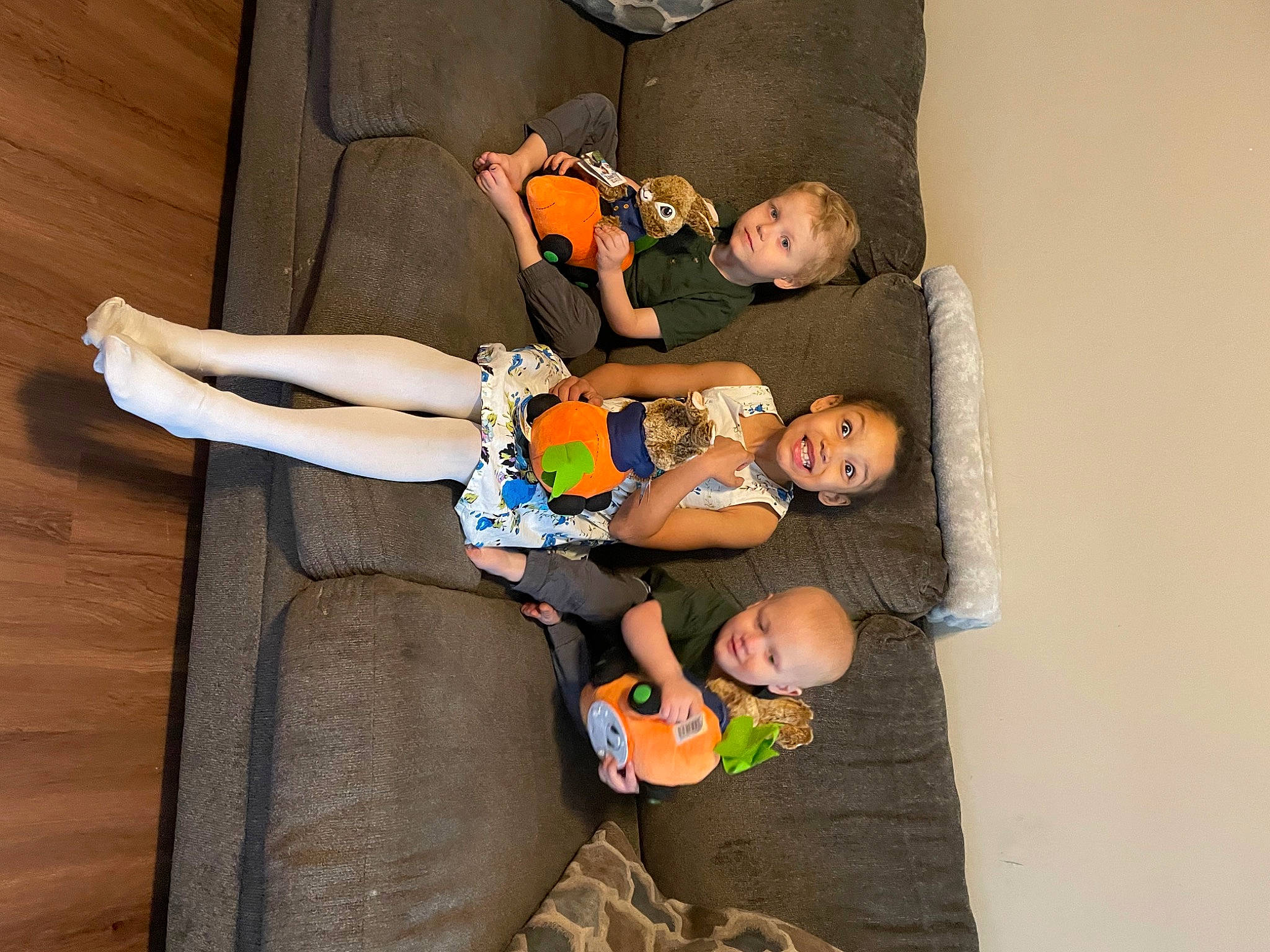 Shanika joined the competition — help win amazing prizes! baby_toddler_clothing, comfort, foot, fun, happy, hardwood, hat, human_leg, joy, lap, leisure, person, room, sitting, smile, sock, t_shirt, thigh, toddler, tree