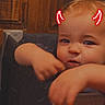 arms, baby, blond_hair, chair, child, closeup, curious, devil_horns, eyes, face, filter, furniture, home, indoor, infant, mischievous, photography, portrait, sitting, wood_paneling