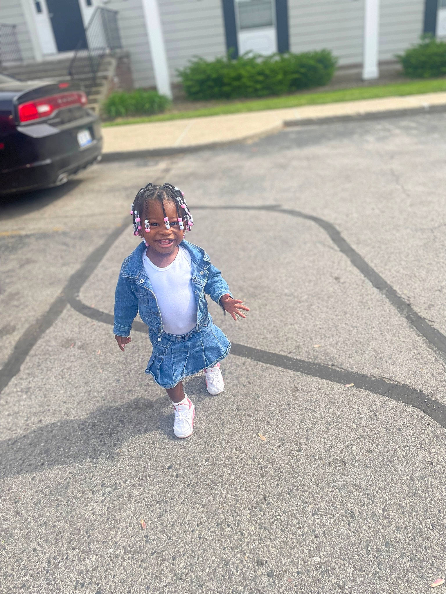 Nalani is registered to the contest to win money with this photo: asphalt, automotive_lighting, automotive_tire, car, child, driveway, electric_blue, grass, line, pedestrian, person, personal_luxury_car, plant, road, road_surface, sidewalk, tar, toddler, vehicle, vehicle_door