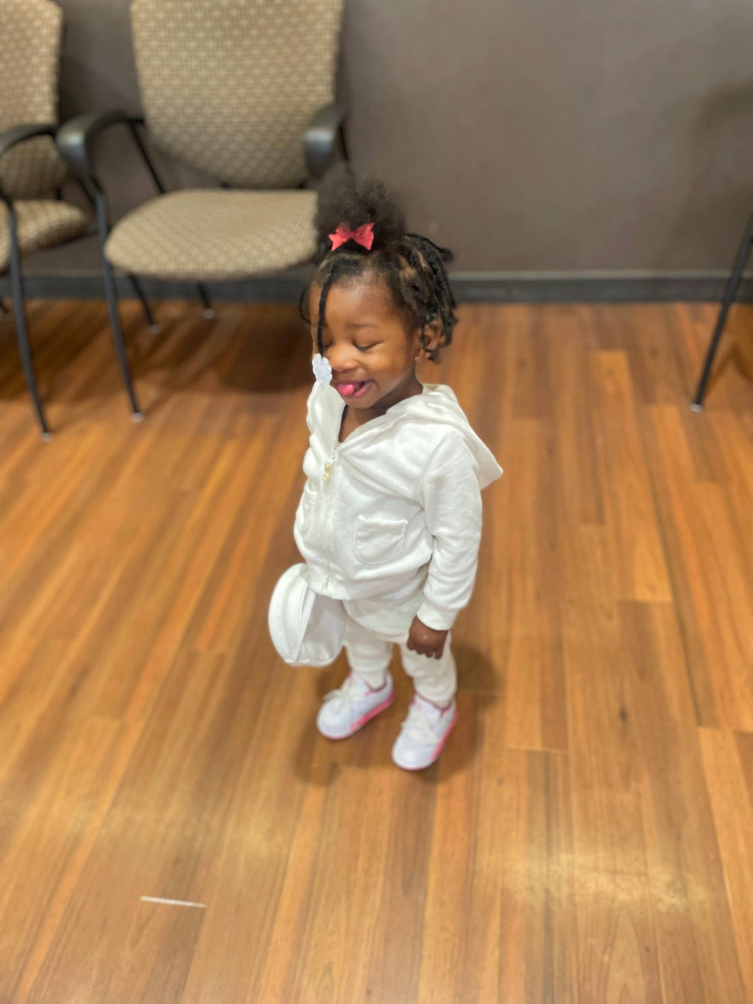 Nalani is registered to the contest to win money with this photo: baby_toddler_clothing, chair, child, clothing, comfort, floor, flooring, happy, hardwood, human_leg, laminate_flooring, leg, person, plank, room, smile, toddler, varnish, wood, wood_flooring