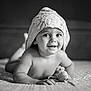 baby, towel, bed, smile, portrait, black_and_white, child, cute, indoor, headwear, happy, infant, blanket, person, skin, face, expression, lying_down, toddler, soft_light
