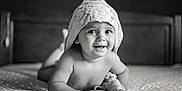Miguel participe au concours pour gagner de l'argent avec cette photo : baby, towel, bed, smile, portrait, black_and_white, child, cute, indoor, headwear, happy, infant, blanket, person, skin, face, expression, lying_down, toddler, soft_light