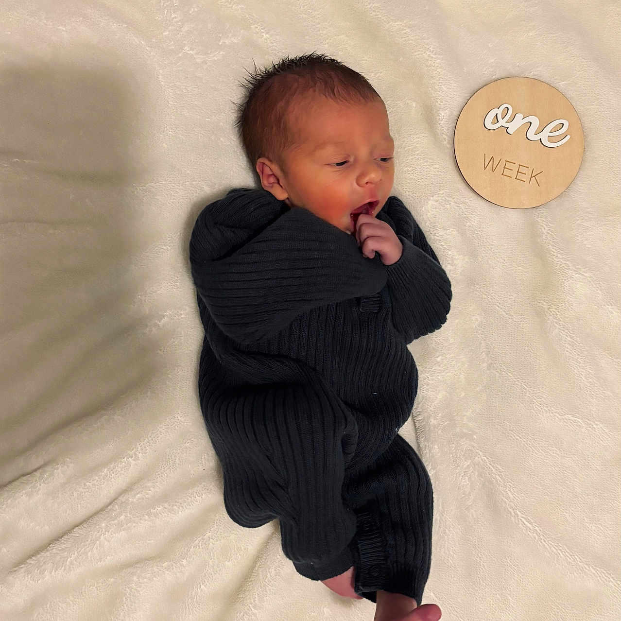 Oliver is registered to the contest to win money with this photo: baby, bodypart, clothing, coat, face, finger, formalwear, hand, head, knitwear, longsleeve, newborn, pants, person, photography, portrait, sleeve, suit, sweater, toe