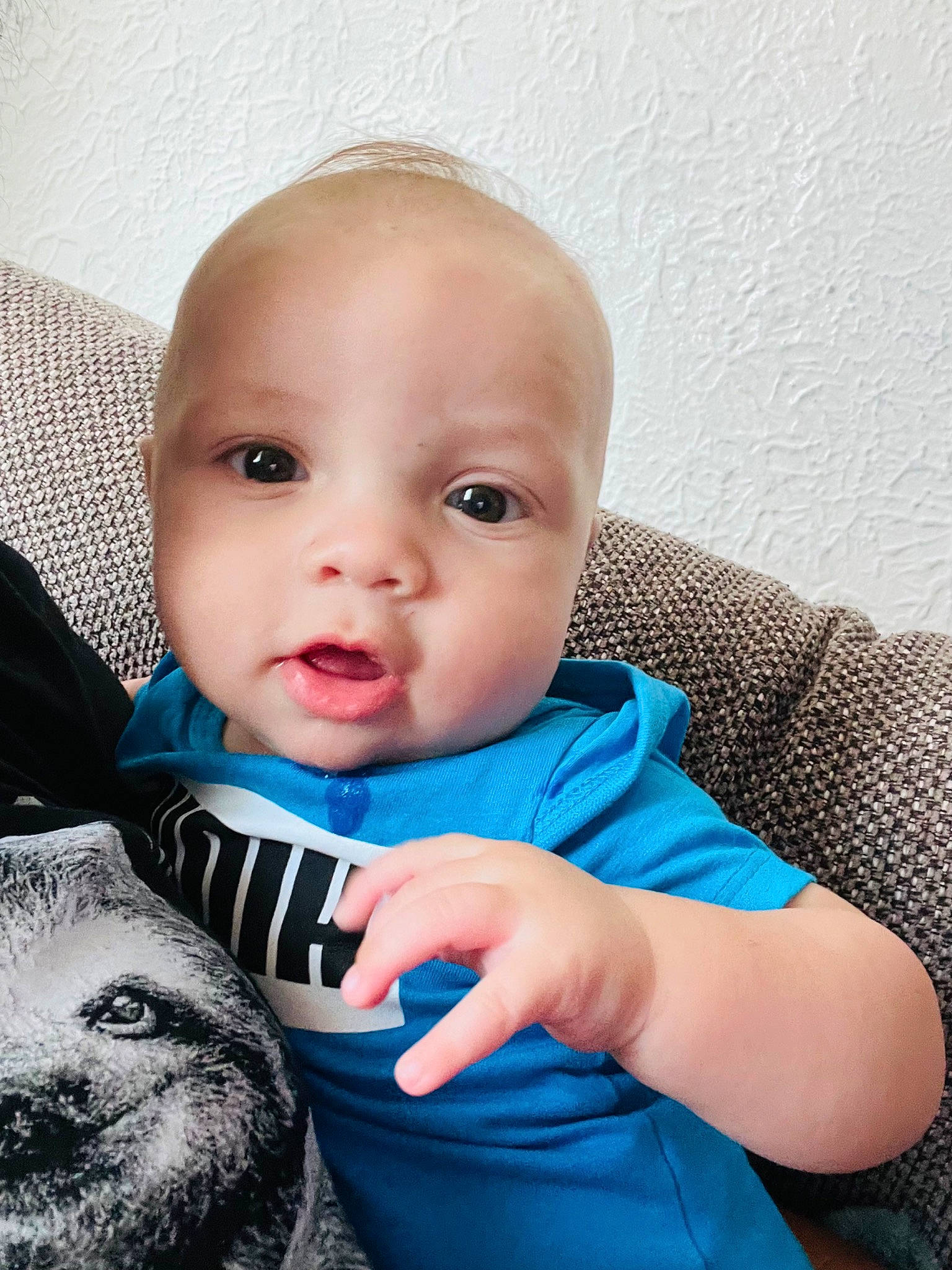 Caiden joined the competition — help win amazing prizes! baby, baby_products, baby_toddler_clothing, cheek, child, comfort, electric_blue, eyelash, finger, flash_photography, fur, gesture, happy, moustache, person, personal_protective_equipment, portrait_photography, sitting, sleeve, t_shirt