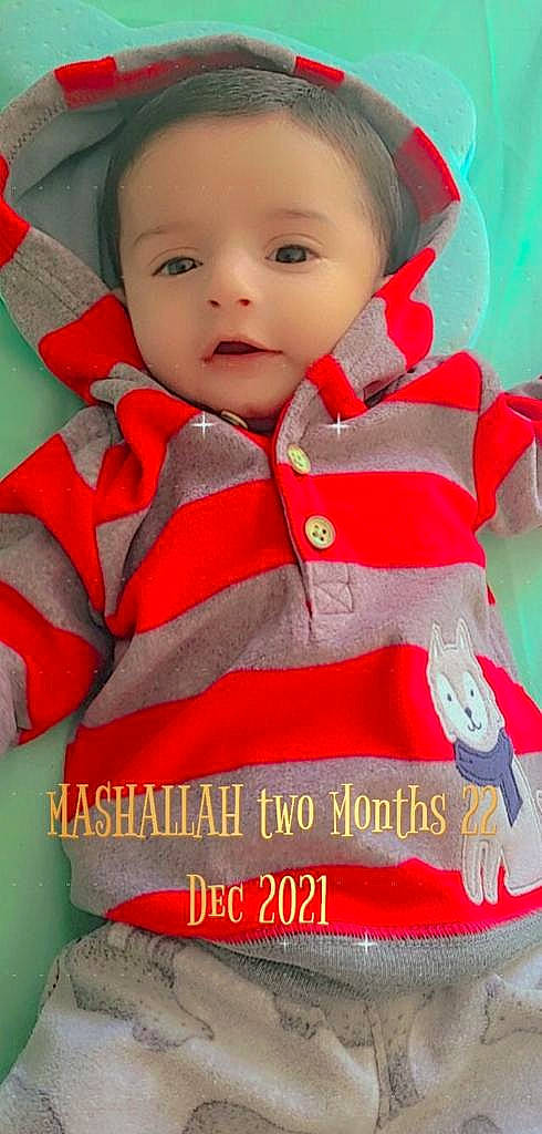 Zohan is registered to the contest to win money with this photo: arm, baby, baby_toddler_clothing, cheek, eye, face, finger, happy, head, iris, jacket, lip, neck, nose, outerwear, person, red, skin, sleeve, smile