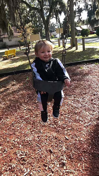 Clayton joined the competition — help win amazing prizes! baby, branch, face, grass, happy, head, jacket, joy, leisure, people_in_nature, person, plant, playground, recreation, sleeve, smile, swing, tints_and_shades, toddler, tree