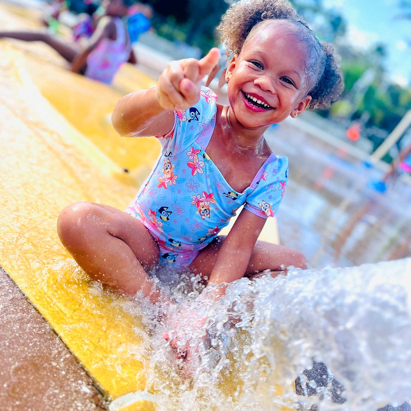 Kamaya is registered to the contest to win money with this photo: amusementpark, baby, child, clothing, face, female, girl, happy, head, laughing, outdoors, person, photography, portrait, sliding, smile, summer, swimwear, water, waterpark