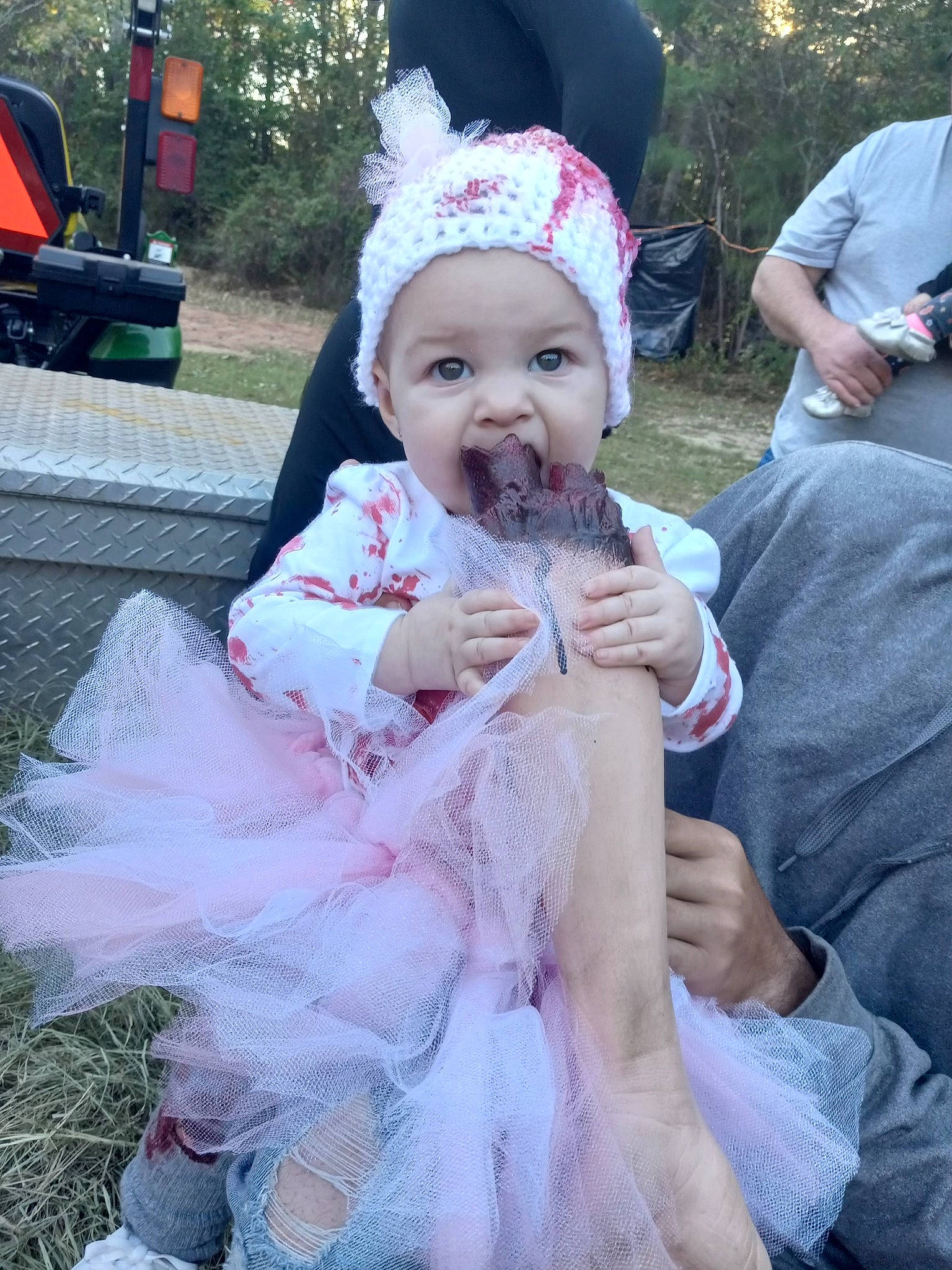 Caroline is registered to the contest to win money with this photo: baby, baby_toddler_clothing, bench, child, costume, costume_hat, event, fun, fur, grass, happy, hat, headwear, holiday, person, pink, plant, recreation, sitting, toddler