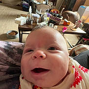 Asher joined the competition — help win amazing prizes! baby, smiling, close_up, blanket, living_room, cat, table, television, furniture, cozy, indoor, person, face, happy, carpet, household_items, pet, animal, couch, decor