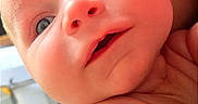 Garrett is registered to the contest to win money with this photo: baby, infant, face, skin, arm, hand, eyes, nose, mouth, cheeks, closeup, portrait, child, person, expression, curious, indoor, soft_light, newborn, cute