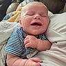 Garrett is registered to the contest to win money with this photo: baby, smiling, infant, closeup, striped_clothing, blanket, couch, person, arm, happy, skin, home, comfort, cute, newborn, portrait, sleepy, child, soft, relaxed