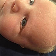 Garrett joined the competition — help win amazing prizes! baby, face, skin, eyes, close_up, infant, portrait, newborn, expression, human, head, child, cute, soft, young, person, detail, reflection, skin_texture, lying_down