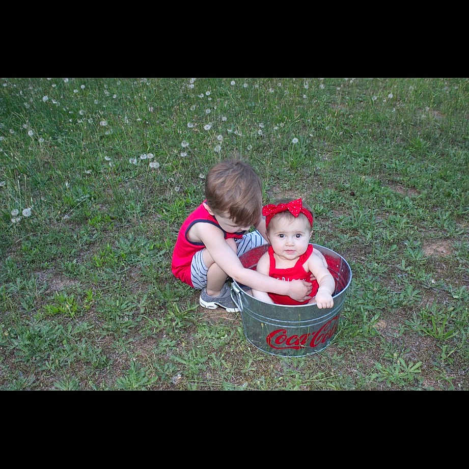 Rylee joined the competition — help win amazing prizes! baby, baby_toddler_clothing, carmine, child, darkness, fictional_character, flash_photography, flooring, grass, happy, landscape, lawn, lawn_ornament, people_in_nature, photo_caption, plant, recreation, sitting, toddler, toy