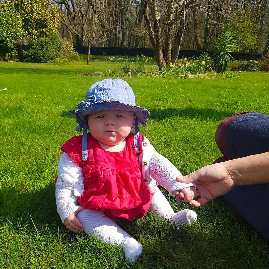 Lilly-mae joined the competition — help win amazing prizes! botany, child, garden, grass, grass_family, headgear, headwear, lawn, leaf, meadow, person, plant, play, recreation, sitting, spring, toddler, tree, vacation
