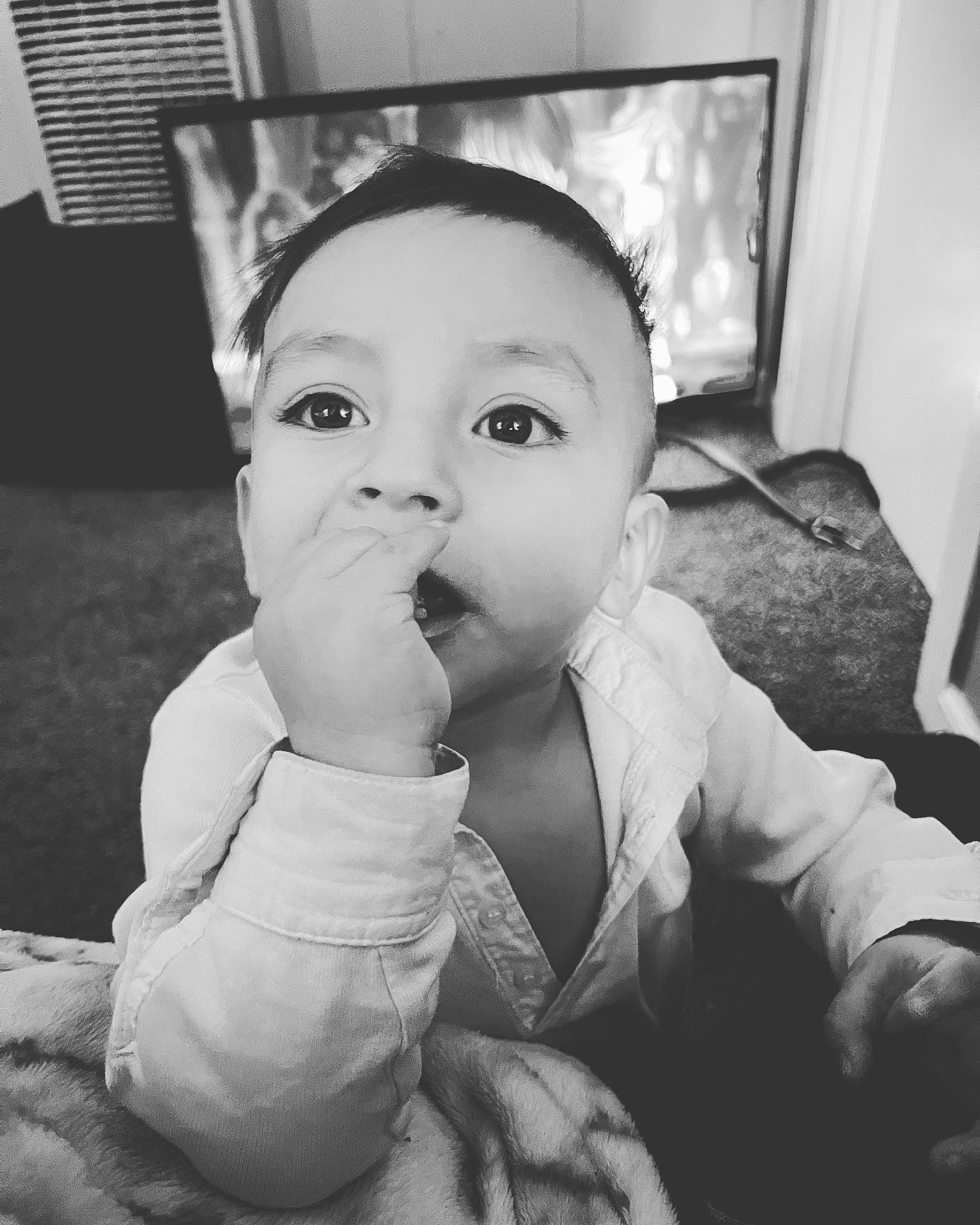Lisandro is registered to the contest to win money with this photo: baby, baby_toddler_clothing, black_and_white, cheek, drinkware, eyebrow, face, flash_photography, gesture, happy, human_body, iris, lip, monochrome, monochrome_photography, mouth, nose, person, style, tableware