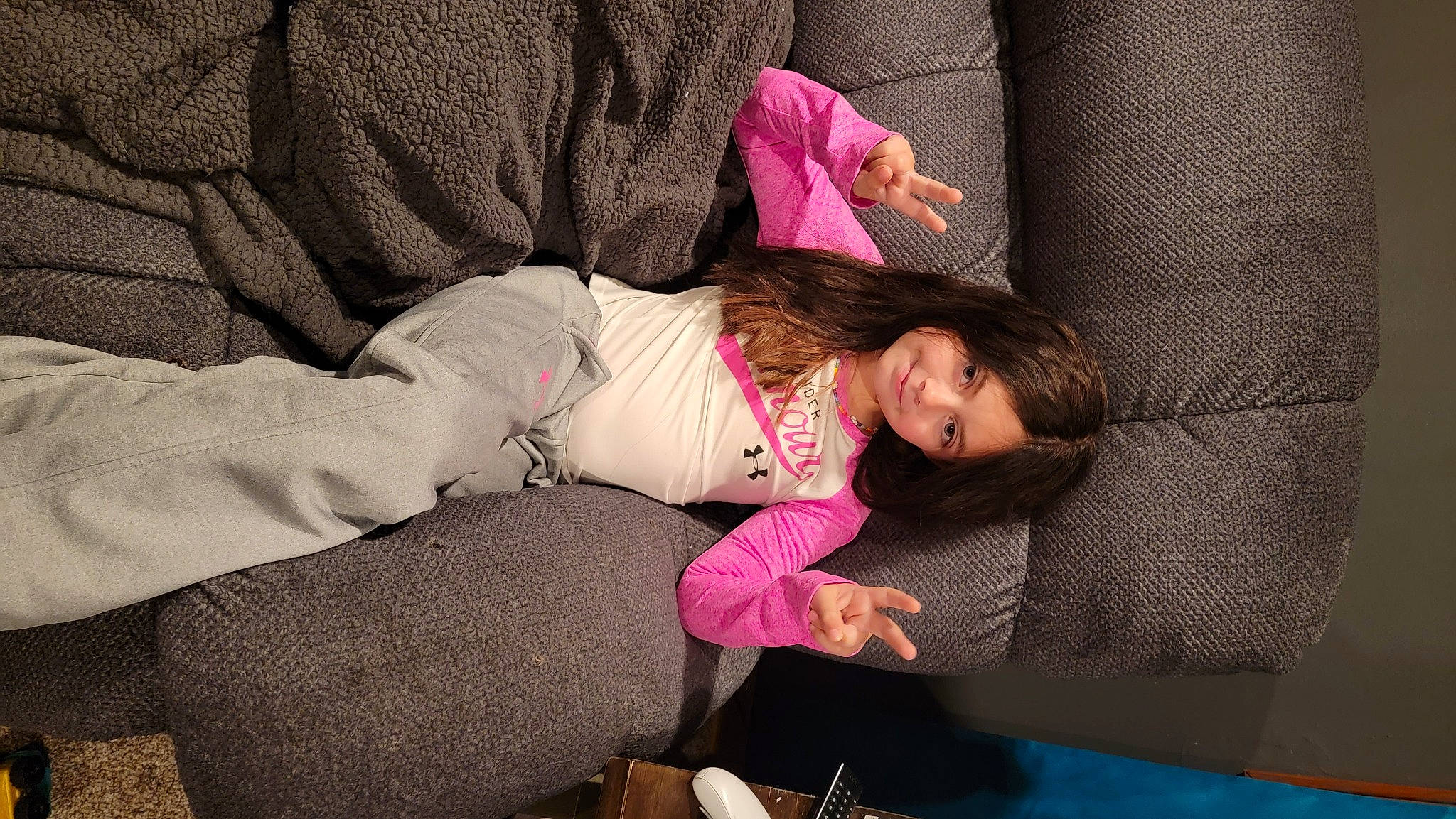 Payzlee is registered to the contest to win money with this photo: child, comfort, couch, flooring, fun, happy, human_leg, joy, knee, leisure, linens, magenta, person, pink, purple, room, sitting, textile, thigh, toddler