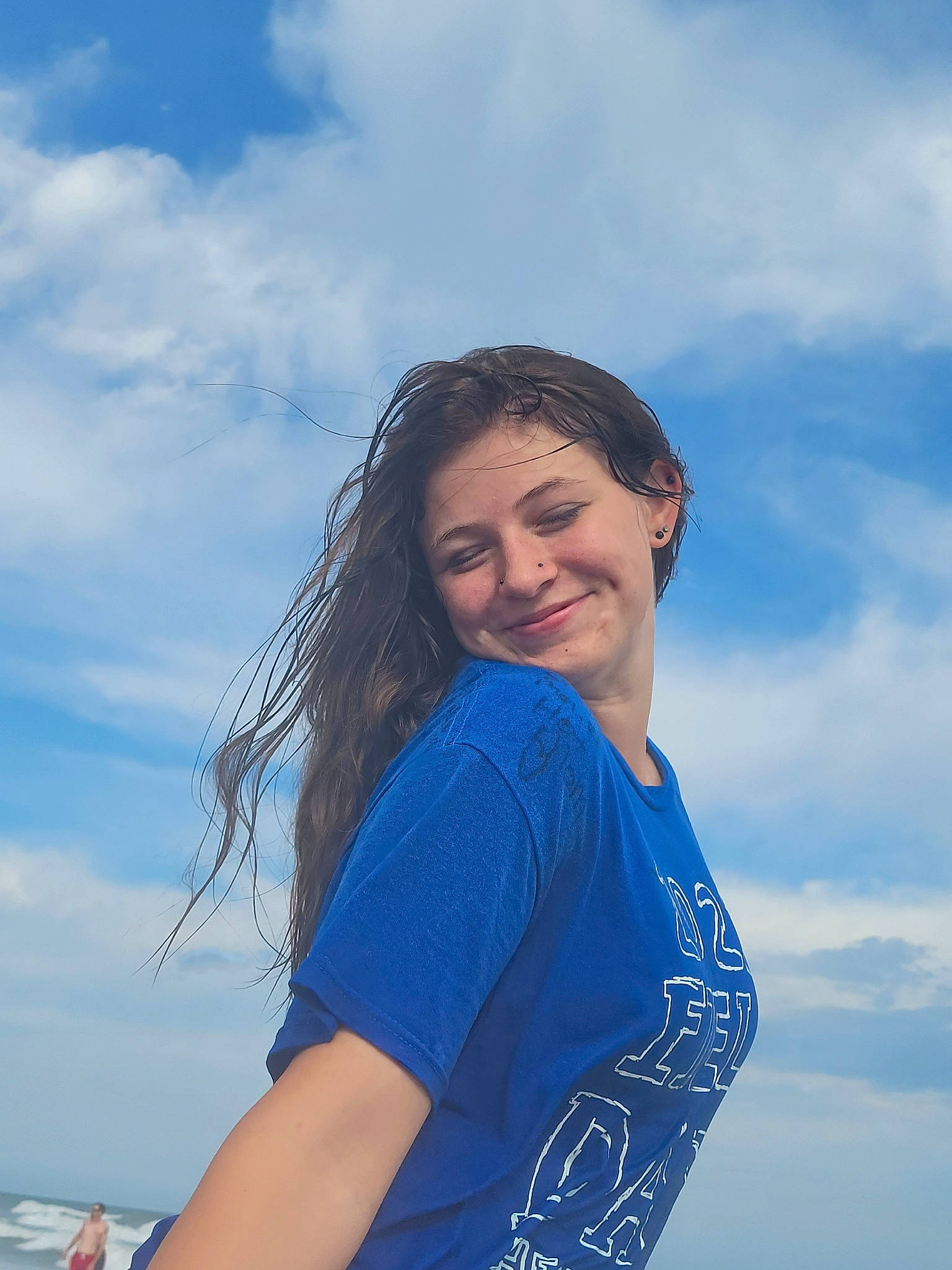 Malia is registered to the contest to win money with this photo: azure, beauty, blue, brown_hair, cloud, coast, elbow, electric_blue, flash_photography, fun, grass, happy, joy, landscape, leisure, long_hair, people_in_nature, person, sky, smile